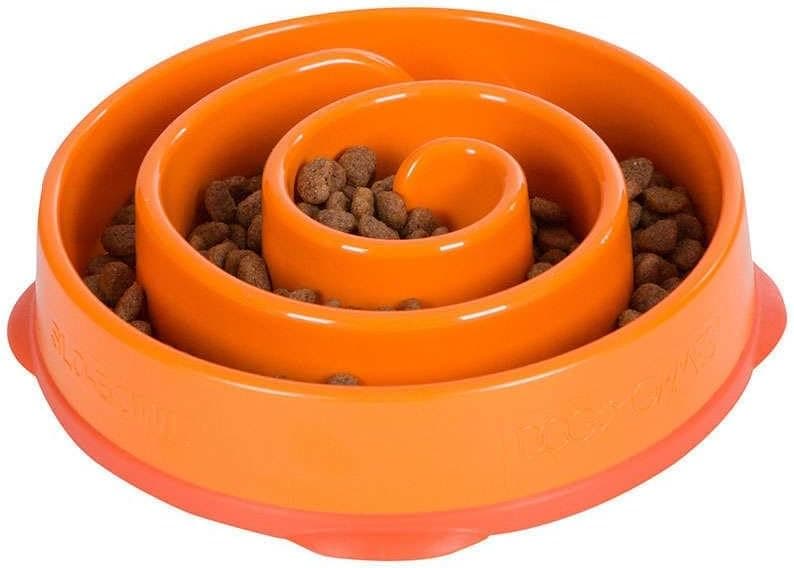 Dog eating slowly from a bowl on the kitchen floor